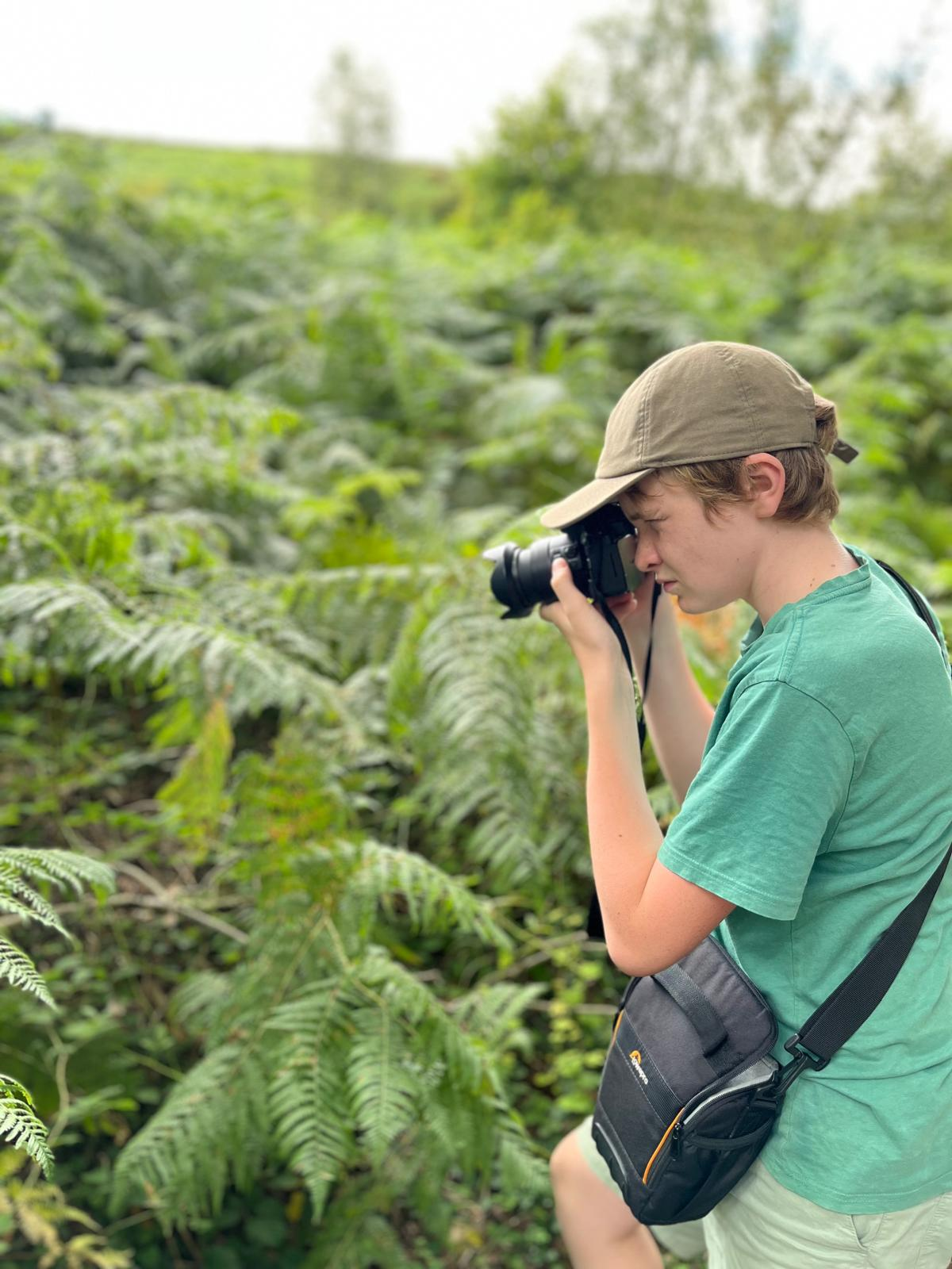 Henry photographing nature with a camera